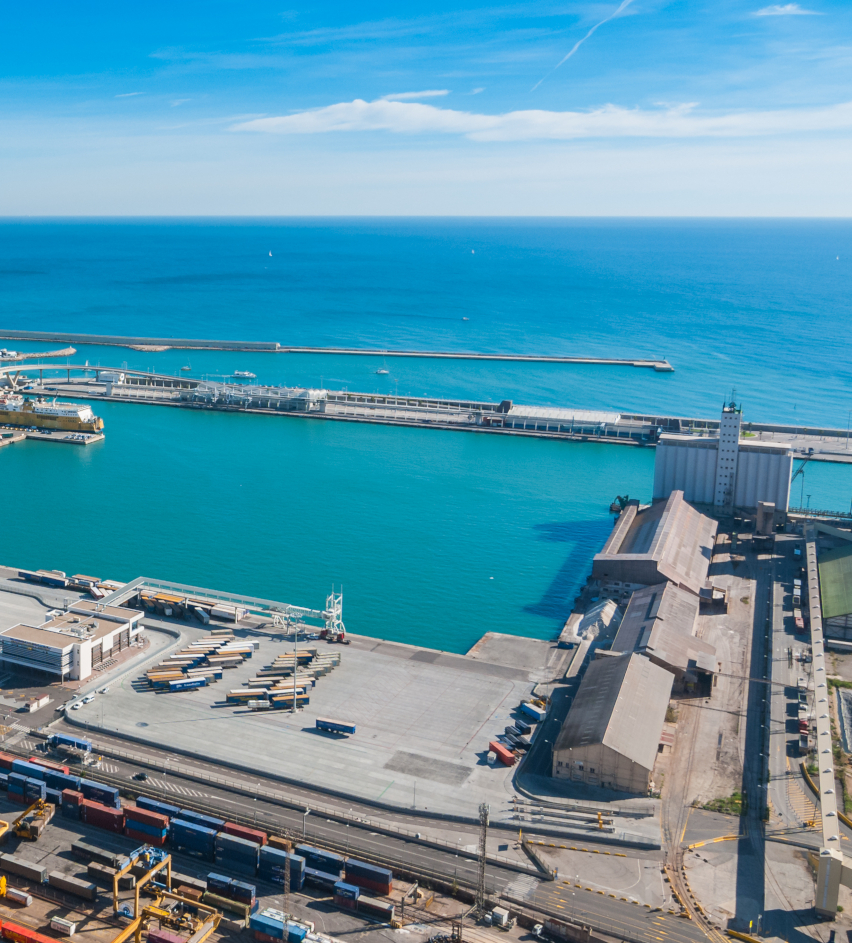 Sunshine on Balearic sea, Barcelona & coastline of Spain, High level view of seaside industrial shipping ports on a blue-sky sunny day.